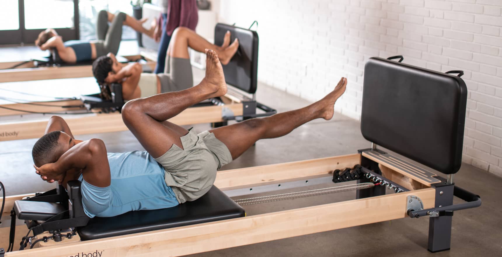 A Pilates reformer fitted with a jumpboard for aerobic cardio training