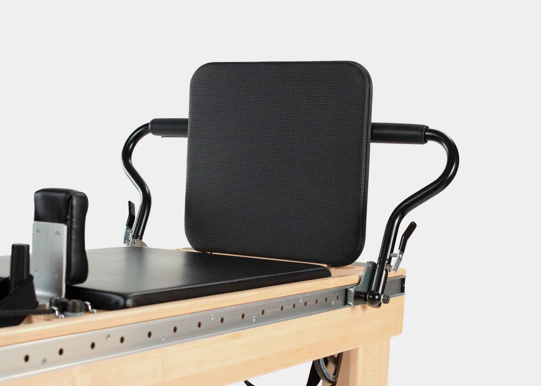 padded jumpboard on clinical reformer with infinity footbar