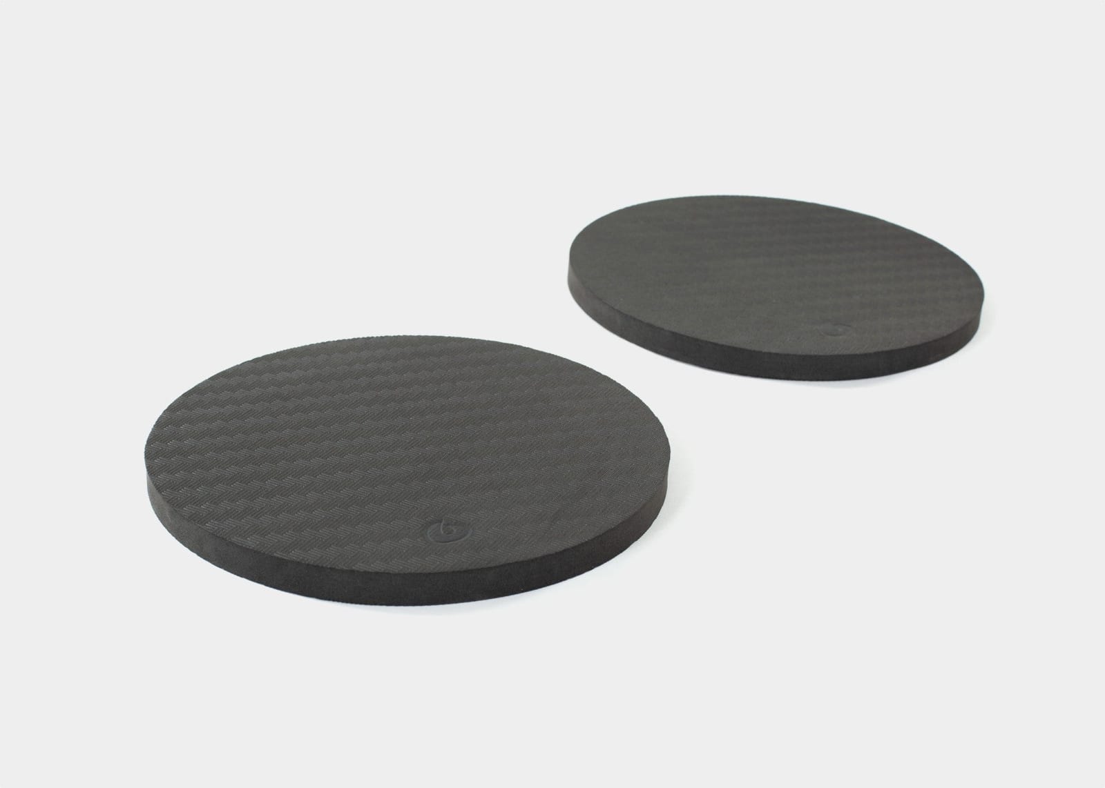 Pair of black rotator disc pads for stability.